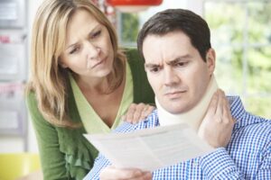 A couple reads a letter regarding the husband's neck injury with respect and concern. 